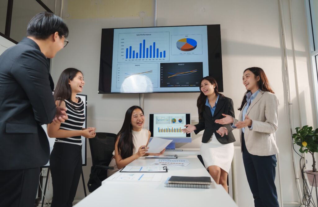 A group of sales professionals celebrating their sales performance.