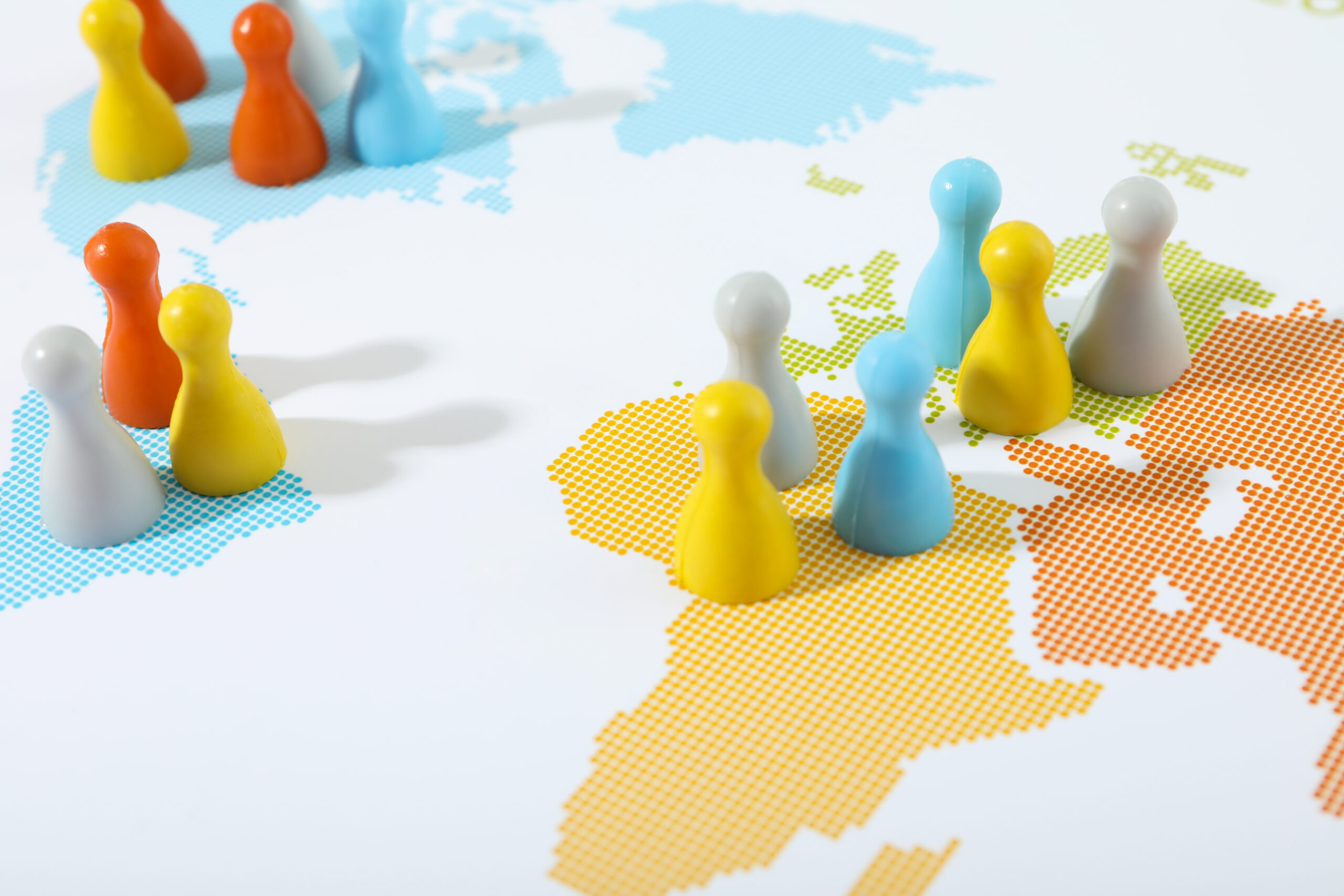 Colorful figures placed across a world map represent global connections and market expansion.